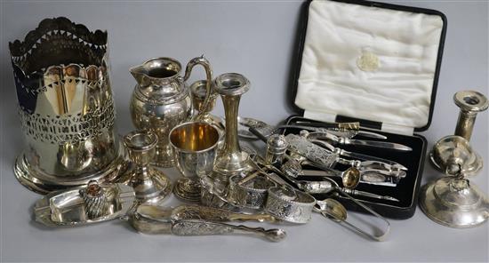 A small collection of silver and plated wares, including silver napkin rings, condiments and dwarf candlesticks.